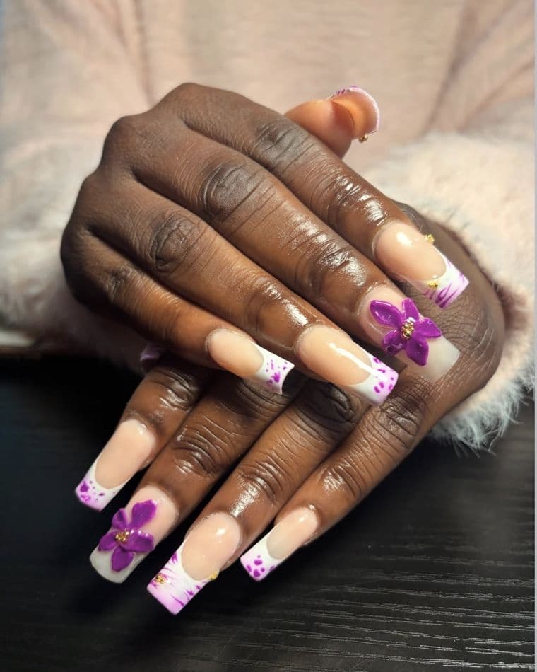 Long coffin nails with white french tips, purple splatter and 3D purple flowers