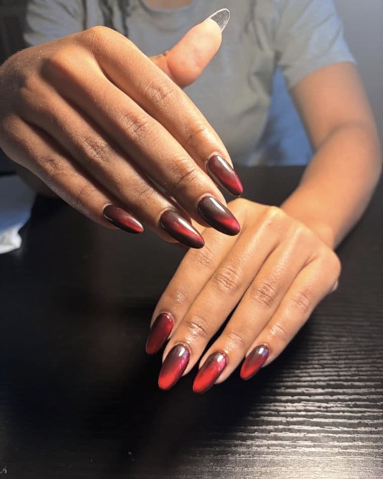 Almond nails in a deep red to black chrome ombre