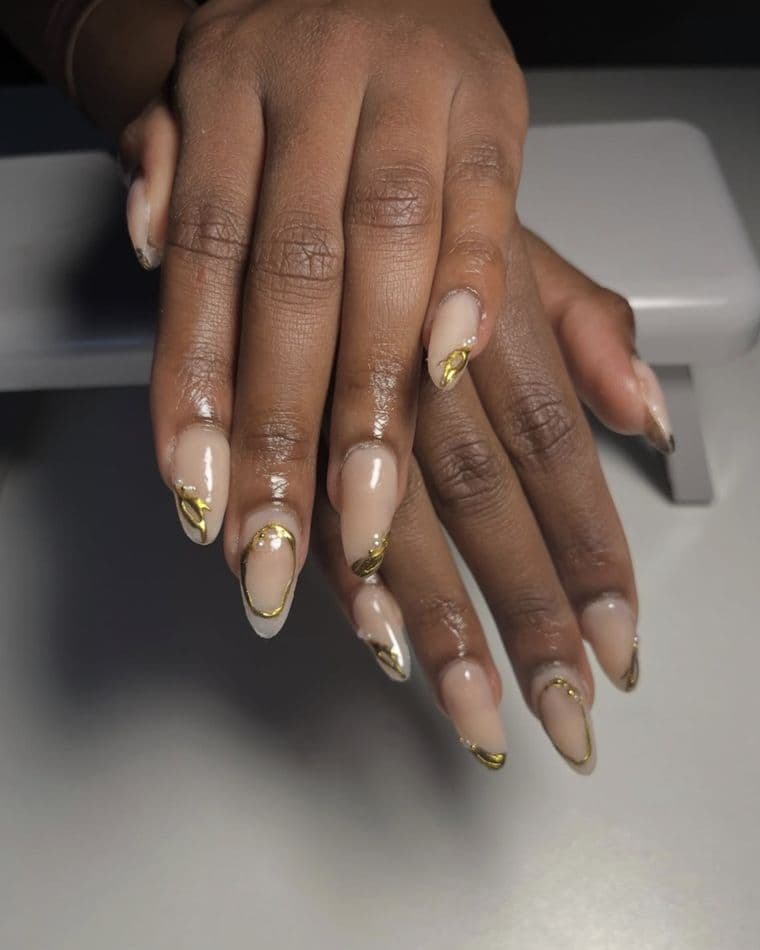 Almond nails with gold chrome wire detailing and pearls on a nude base