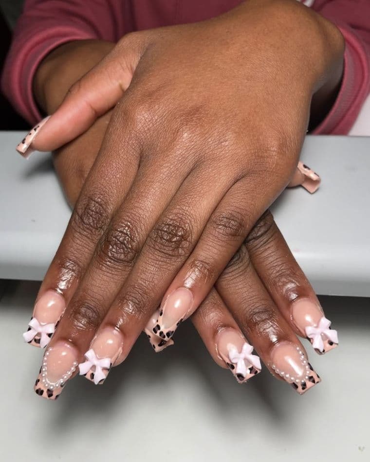 Coffin nails with leopard print french tips, 3D white bows and pearls
