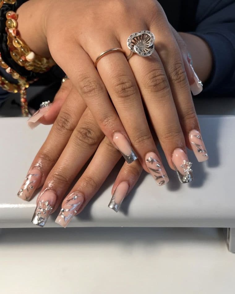 Coffin nails with silver chrome tips, freehand line art and star charms