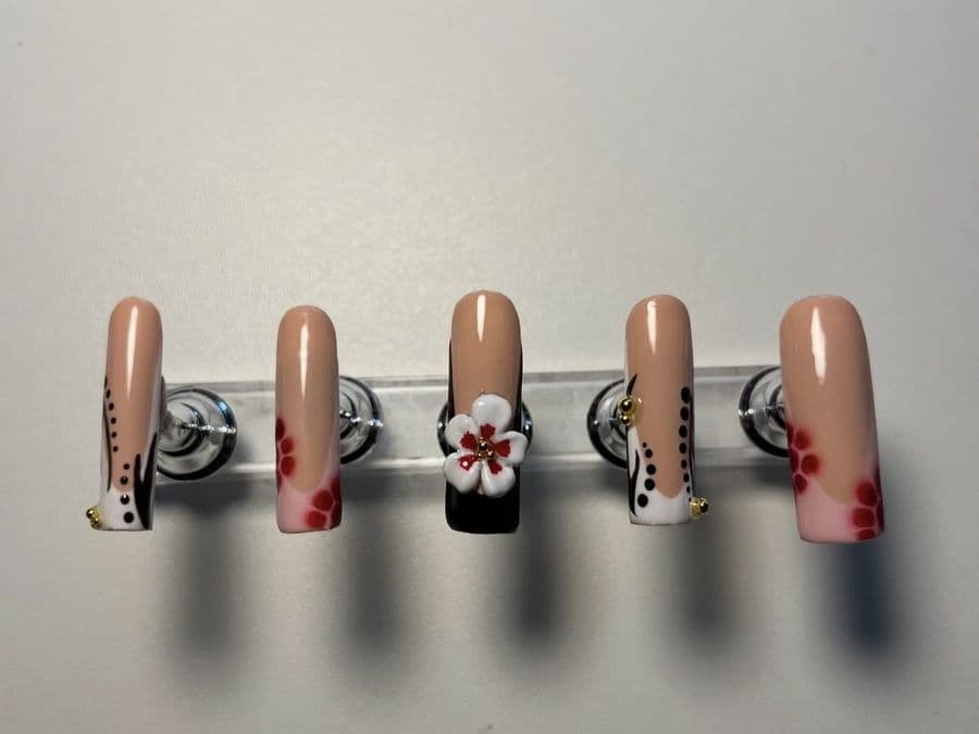Press-on long square set with black tips, a 3D blossom and freehand dot work
